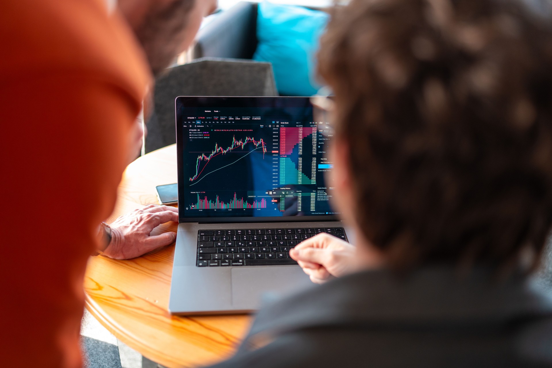 Diverse Young Investors Analyzing Stock Market on Laptop